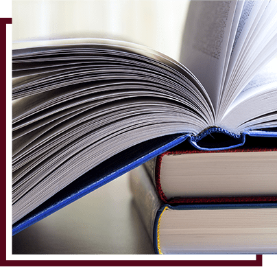 stack of three books with the top book open