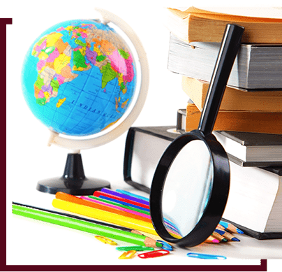 magnify glass next to stack of school supplies and globe