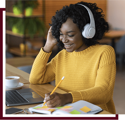 girl with headphones working on school work