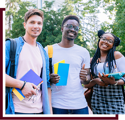 three students standing together smiling and holding notebooks